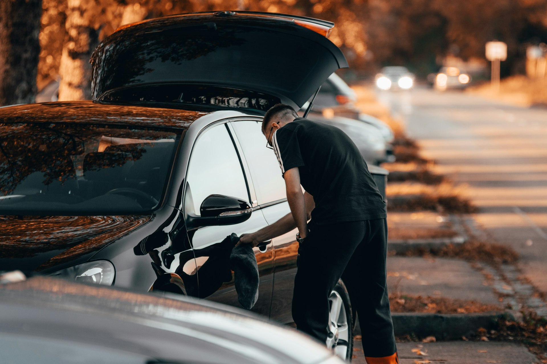 a man working on a car on the side of the road